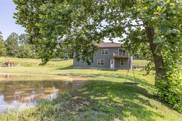view of yard with a deck with water view