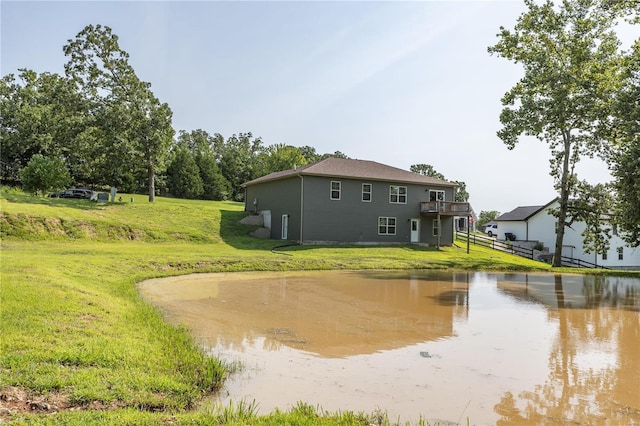 exterior space featuring a lawn and a water view