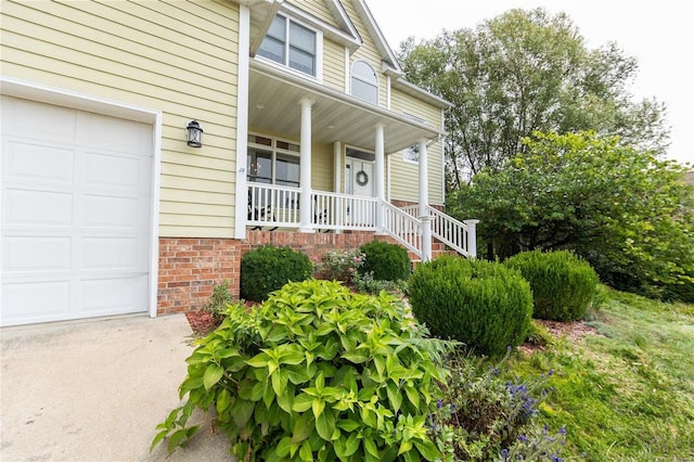 entrance to property with a porch and a garage