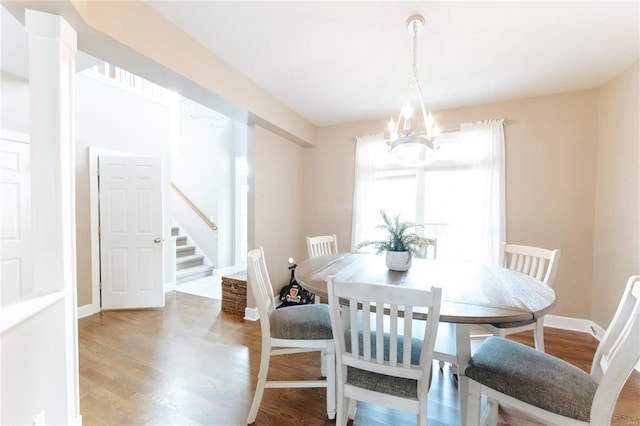 dining area featuring a chandelier and light wood-type flooring