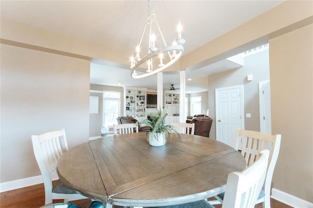 dining room with ceiling fan with notable chandelier