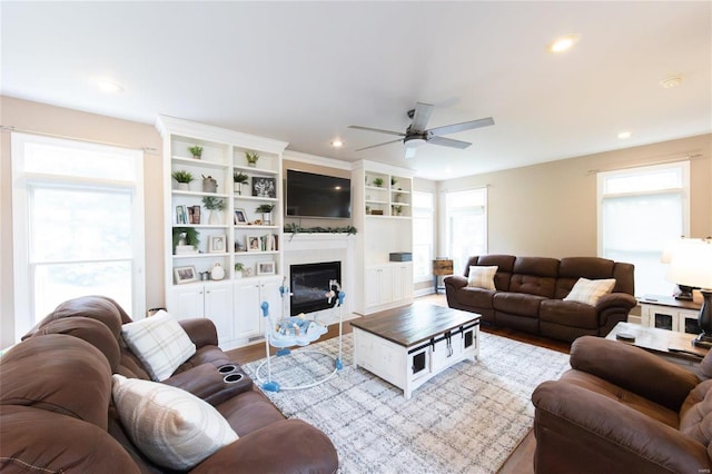 living room featuring ceiling fan and light hardwood / wood-style floors