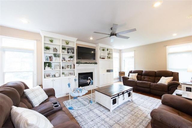 living room with hardwood / wood-style flooring and ceiling fan