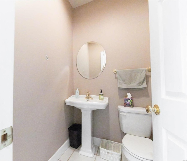 bathroom with tile patterned flooring, sink, and toilet