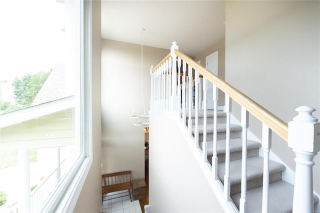 stairs featuring an inviting chandelier