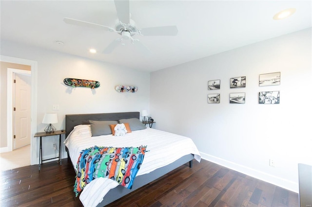 bedroom with dark hardwood / wood-style floors and ceiling fan