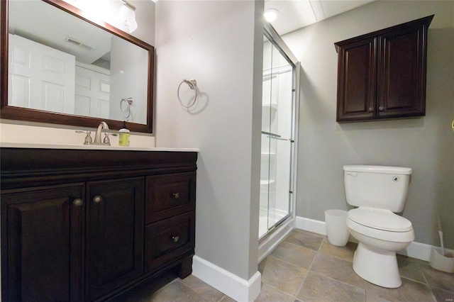 bathroom featuring vanity, an enclosed shower, and toilet