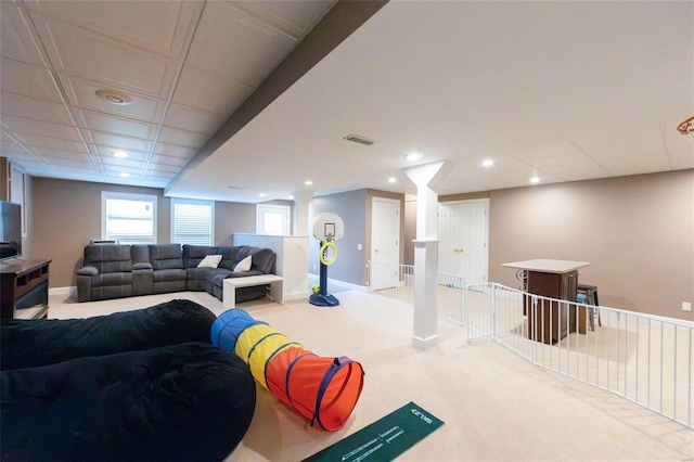 living room with a paneled ceiling and carpet