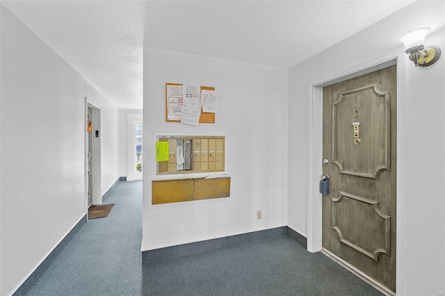 foyer featuring carpet and a textured ceiling