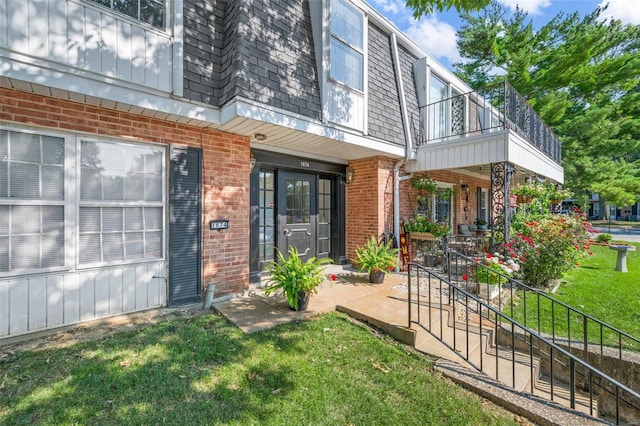 doorway to property with a yard