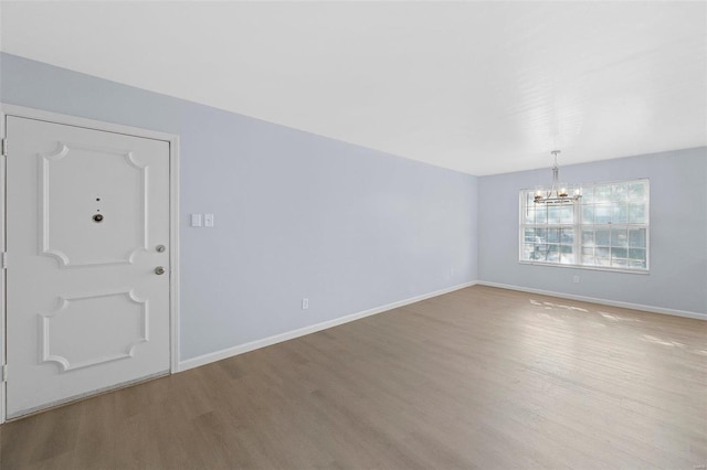 entryway with a notable chandelier and wood-type flooring