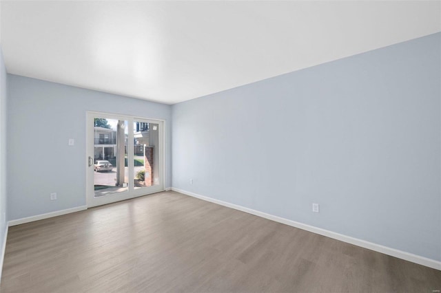 spare room with hardwood / wood-style flooring