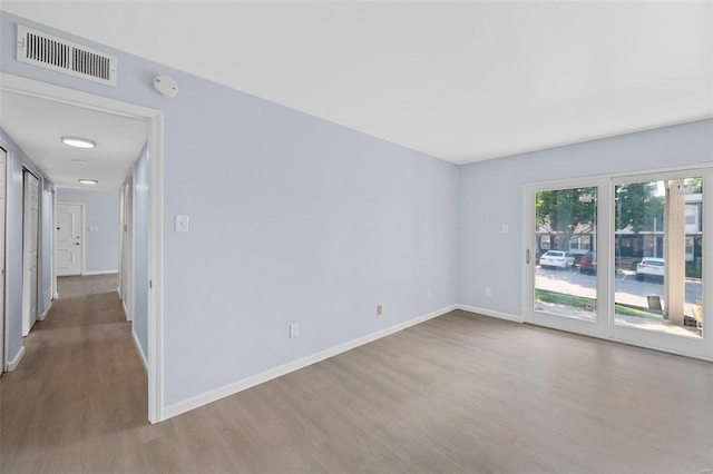 unfurnished room with wood-type flooring