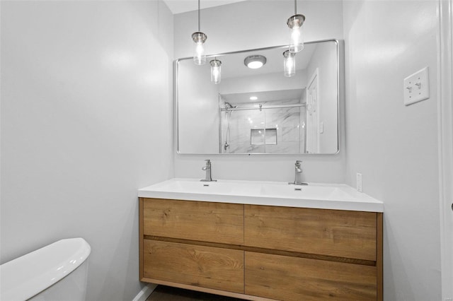 bathroom featuring double sink vanity and toilet