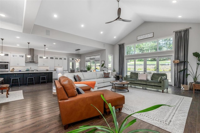 living room featuring high vaulted ceiling, dark hardwood / wood-style floors, sink, and ceiling fan