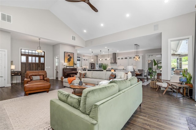 living room with ceiling fan, dark hardwood / wood-style floors, and high vaulted ceiling