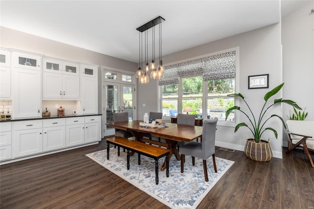 dining room with a notable chandelier and dark wood-type flooring