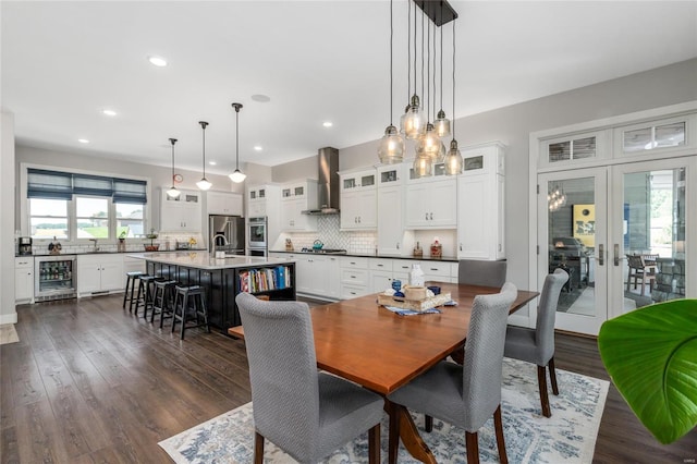 dining area featuring wine cooler, dark wood-type flooring, and french doors