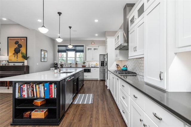 kitchen with sink, white cabinets, pendant lighting, an island with sink, and dark hardwood / wood-style flooring