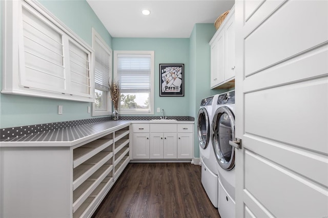 laundry room with cabinets, dark hardwood / wood-style flooring, sink, and washer and dryer