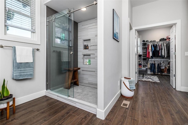 bathroom featuring hardwood / wood-style floors and walk in shower