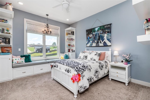 bedroom featuring ceiling fan with notable chandelier and light carpet