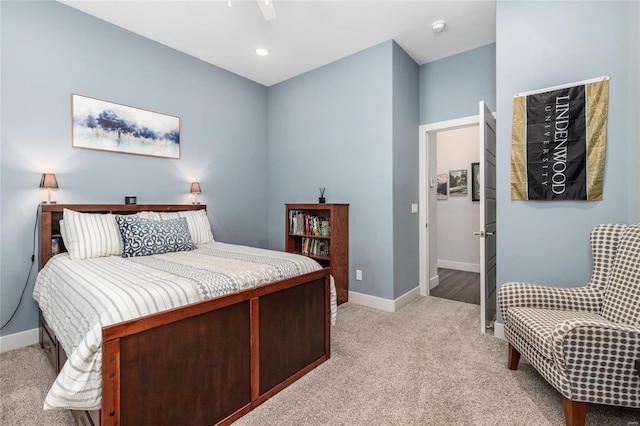 bedroom featuring ceiling fan and light carpet