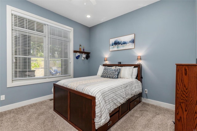 bedroom with ceiling fan and light carpet