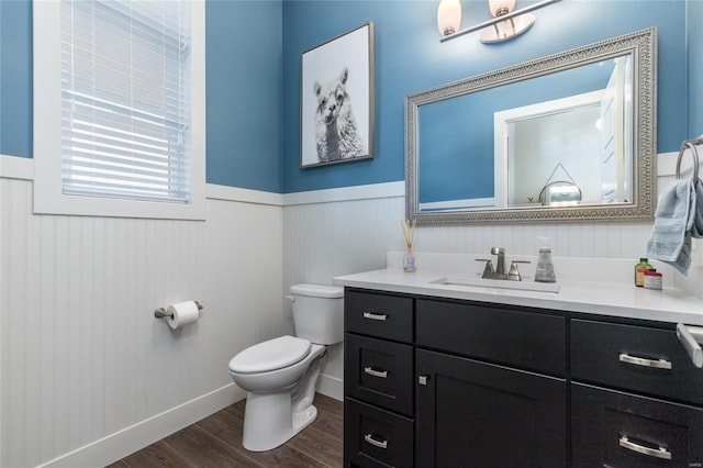 bathroom featuring toilet, vanity, and hardwood / wood-style flooring