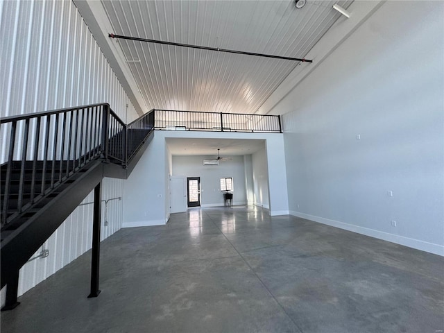 unfurnished living room with a high ceiling