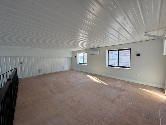 unfurnished room featuring a wall mounted air conditioner