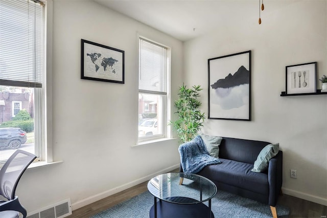 living area with hardwood / wood-style flooring