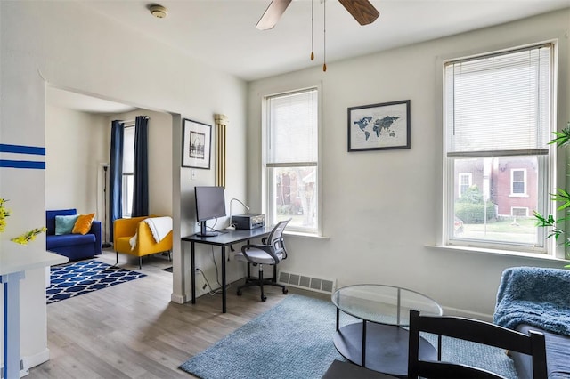 home office with ceiling fan and light wood-type flooring