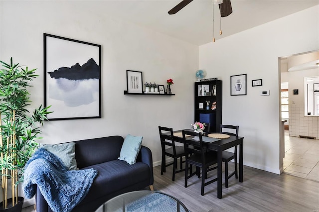 dining area with hardwood / wood-style flooring and ceiling fan