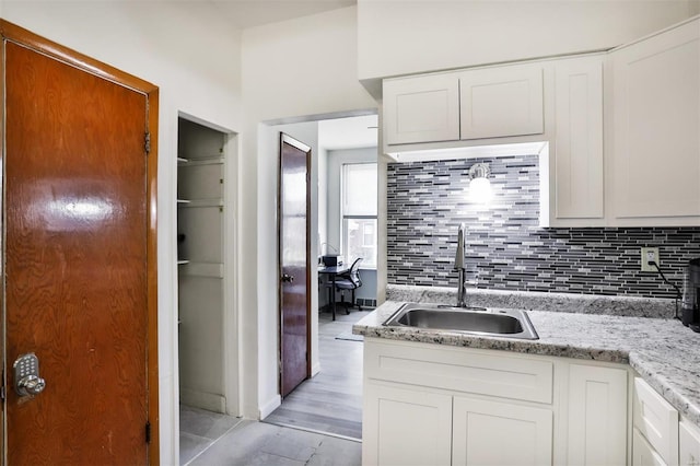 kitchen featuring sink and white cabinets