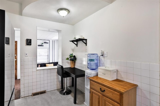 bathroom with tile walls and tile patterned flooring