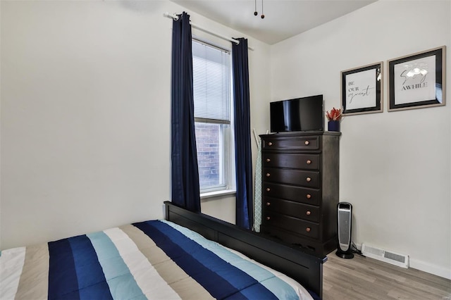 bedroom featuring light hardwood / wood-style flooring and multiple windows