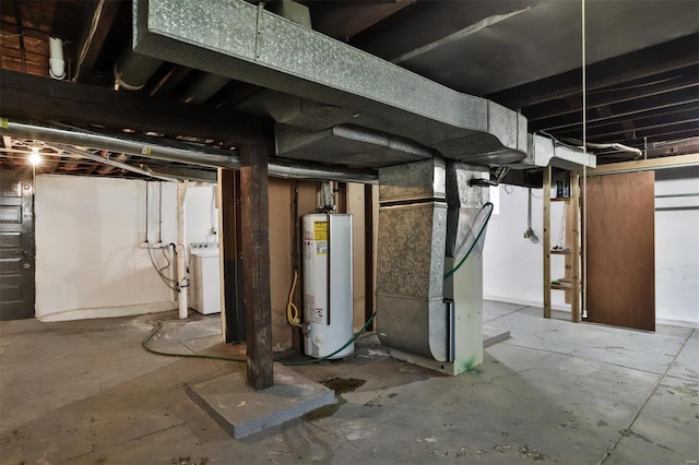 basement with washer / clothes dryer, heating unit, and gas water heater