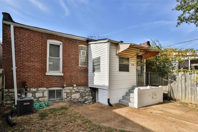 rear view of property with central AC unit