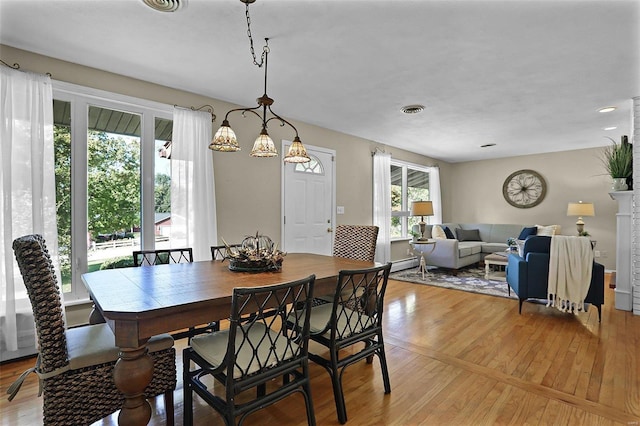 dining area featuring light wood-type flooring and plenty of natural light