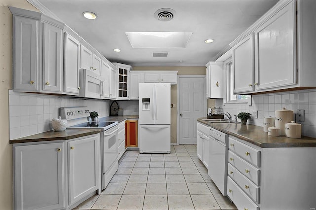 kitchen featuring light tile patterned flooring, white appliances, sink, backsplash, and white cabinets