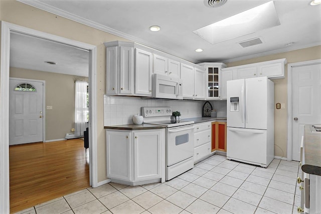 kitchen featuring tasteful backsplash, white cabinets, white appliances, light hardwood / wood-style floors, and ornamental molding