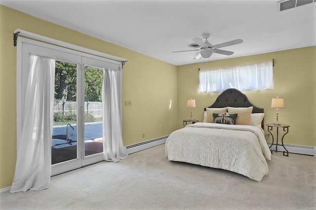 bedroom with access to exterior, multiple windows, ceiling fan, and a baseboard radiator