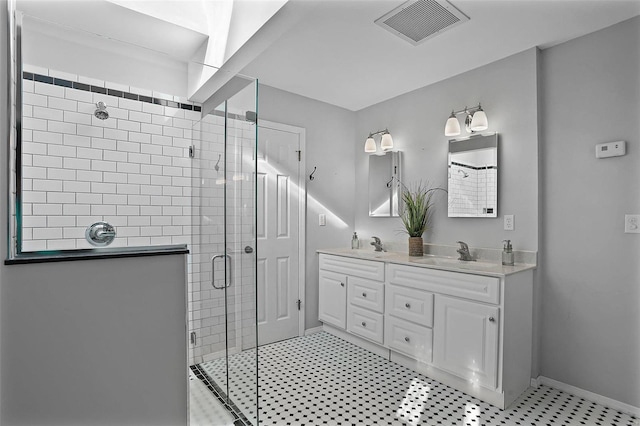 bathroom with a shower with door and vanity