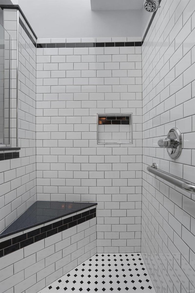 bathroom with a tile shower