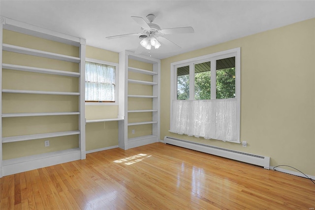 empty room with ceiling fan, a baseboard radiator, and hardwood / wood-style floors