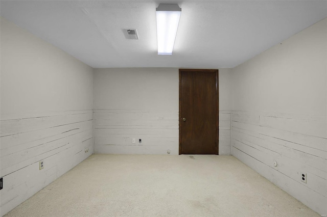 spare room with wood walls