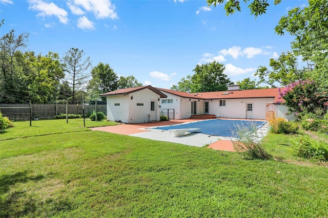 back of property featuring a yard and a patio