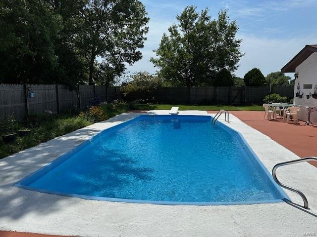 view of pool featuring a patio and a diving board