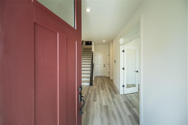 hallway with light hardwood / wood-style floors